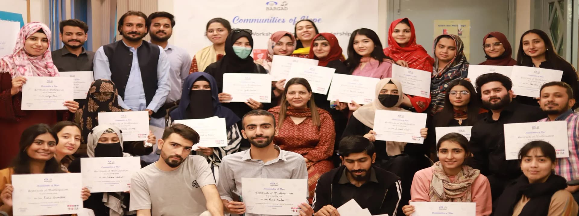 Youth holding certificates of a civic education course